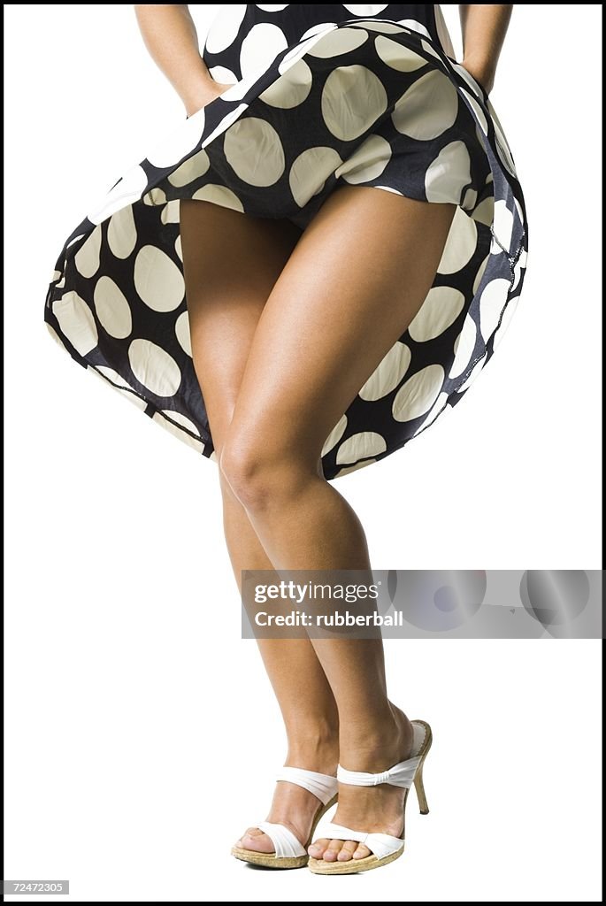 Woman's polka dot dress blowing in breeze