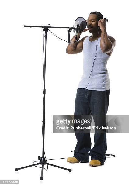african american man singing into microphone - rapper isolated stock pictures, royalty-free photos & images