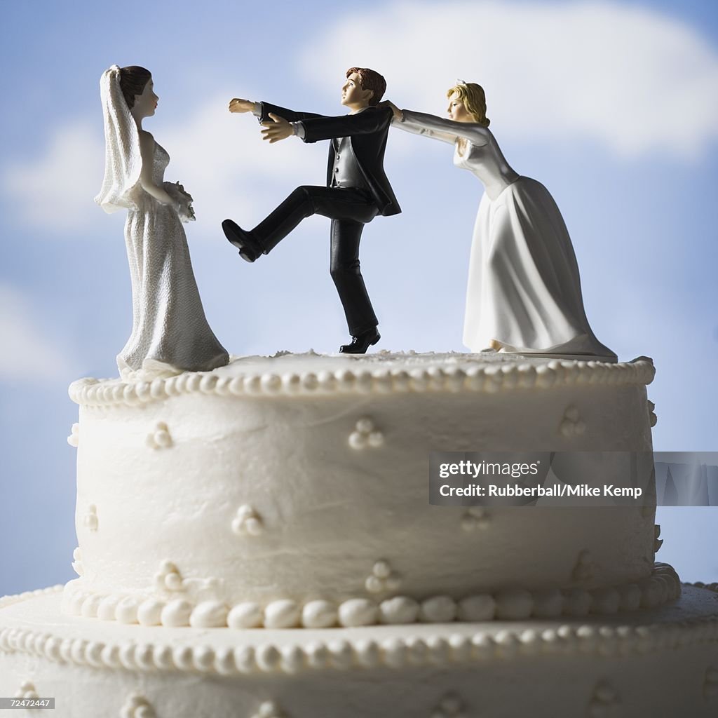 Wedding cake visual metaphor with figurine cake toppers