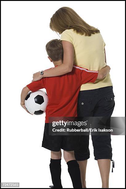 soccer mom with son - soccer mum stock-fotos und bilder