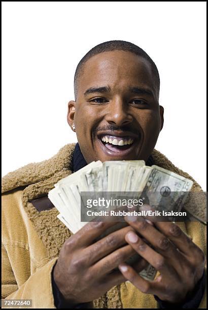 african american holding a pile of dollar bills - earring hook stock pictures, royalty-free photos & images