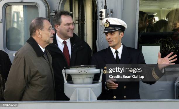 European Union foreign policy chief Javier Solana , German Defense Minister Franz Josef Jung and ship captain Frank Martin stand on the bridge of the...