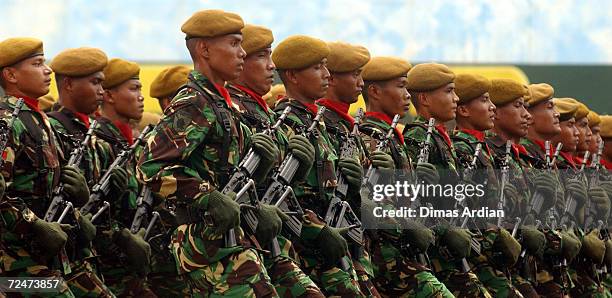 Soldiers from the Indonesian army's Strategic Command march with their rifles during the elite unit's 46th anniversary March 6, 2003 in Jakarta,...