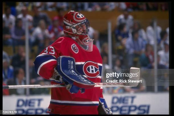 Center John LeClair of the Montreal Canadiens fights with a Buffalo Sabres player during a game at Memorial Auditorium in Buffalo, New York....