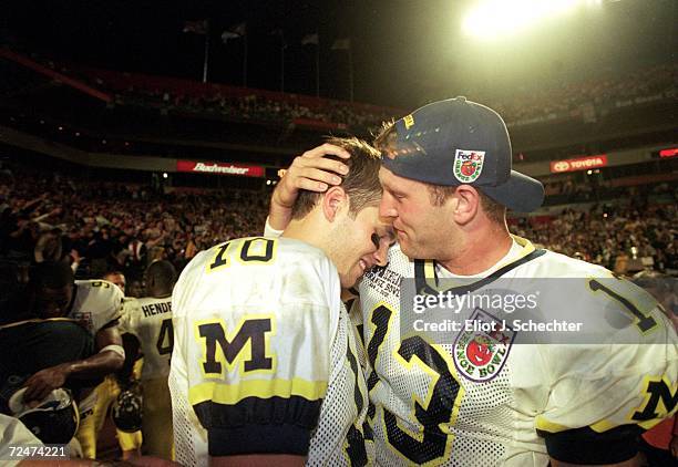 Tom Bradly and Jason Kapner of the Michigan Wolverines celebrate after winning the Orange Bowl Game against the Alabama Crimson Tide at the Pro...