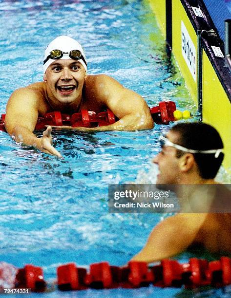 Matt Dunn of Australia wins gold in the 200m Individual Medley and is congratulated by James Hickman of England who won silver during the 1998...