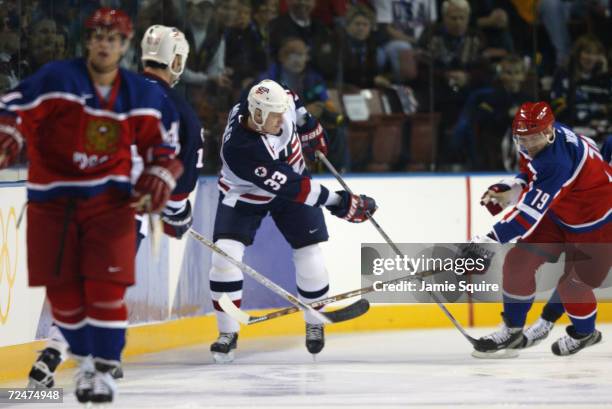 Aaron Miller of the USA and Alexei Yashin of Russia try to gain control of the puck during the Salt Lake City Winter Olympic Games at the E Center in...