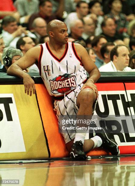 Forward Charles Barkley of the Houston Rockets watches the action from the scorers table during his final NBA game at the Houston Summit in Houston,...