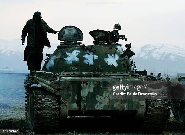 Afghan soldiers warm up their tanks March 9, 2002 in the desert plains outside of Gardez, Afghanistan. Between 700 to 1,000 soldiers with 20 tanks...