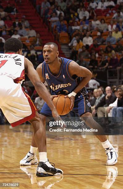 Chris Whitney of the Washington Wizards is defended by Rod Strickland of the Miami Heat during their game at American Airlines Arena in Miami,...