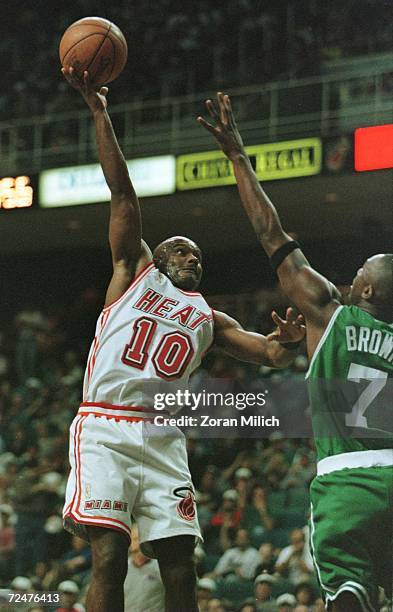 Guard Tim Hardaway of the Miami Heat flings himself past Guard Dee Brown of the Boston Celtics during first quarter action in their 78-77 win over...