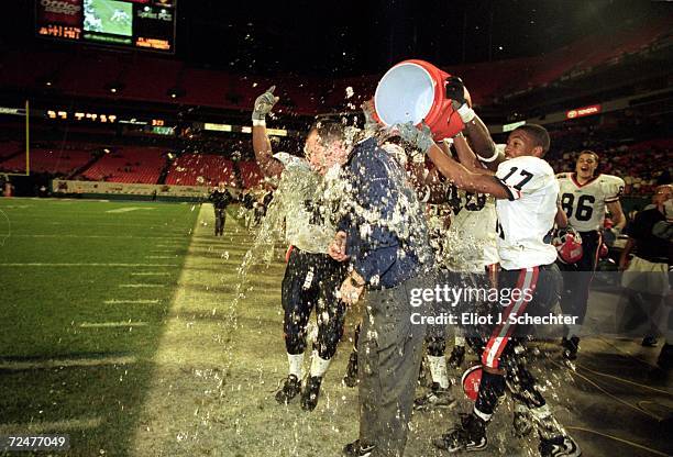 Coach Ron Turner of the Illinois Fighting Illini has the Gatorade poured over him after the Micron PC Bowl Game against the Virginia Cavaliers at the...