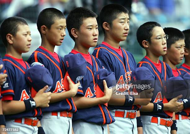 The team from Japan stands as their National Anthem is played before they play Canada in the International Semifinals of the Little League World...