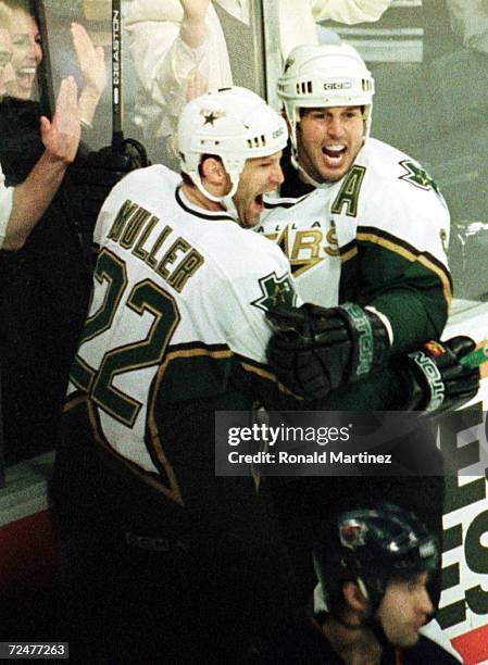 Kirk Muller of the Dallas Stars celebrates his goal with Mike Modano against the Edmonton Oilers in the first period at Reunion Arena in Dallas,...