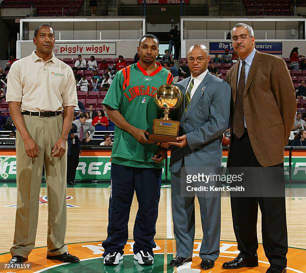 Fred House of the North Charleston Lowgators receives his trophy for NBDL Rookie of the Year with, left to right, coach Alex English, Quenton Tin,...
