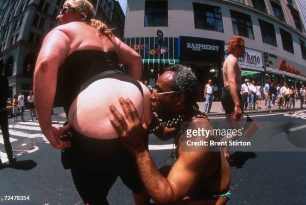 One participant kisses another during the Gay Pride Parade June 27, 1999 in New York City. The Gay Pride Parade is organized for and on behalf of all...