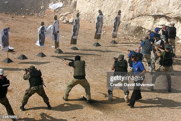 International Security Academy instructor Zafrir Pazi supervises ISA trainees who open fire with assault weapons and handguns on "terror" targets...