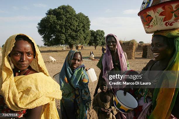 Sudanese refugees are seen in front of their shelter on November 8, 2006 in the Goz Amer Refugee Camp, Chad. Since 2004 refugees have fled from...