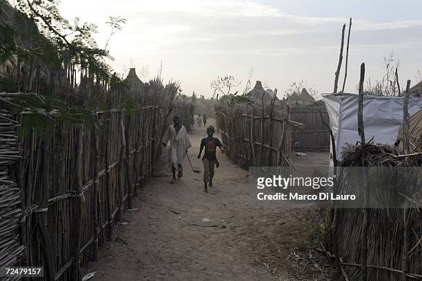 Sudanese refugee boys run and play between the shelters on November 8, 2006 in the Goz Amer Refugee Camp, Chad. Since 2004 refugees have fled from...