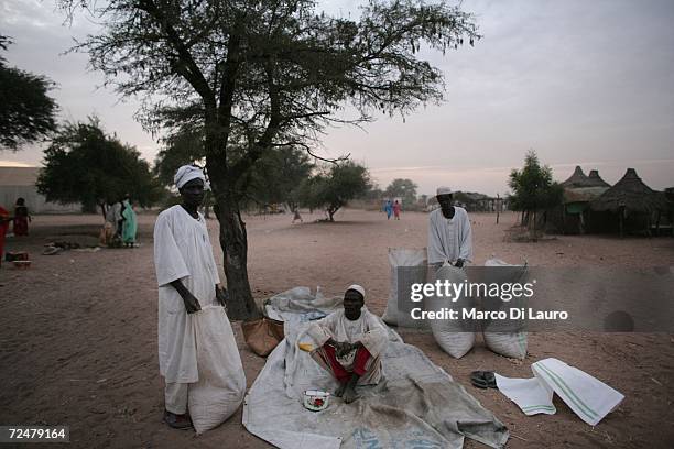 Sudanese refugee men buy and sell what meagre goods they have at market on November 8, 2006 in the Goz Amer Refugee Camp, Chad. Since 2004 refugees...