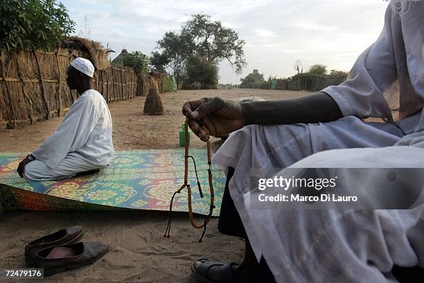 Sudanese refugee men pray on November 8, 2006 in the Goz Amer Refugee Camp, Chad. Since 2004 refugees have fled from Darfur into the province of Kou...