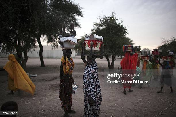 Sudanese refugee women buy and sell what meagre goods they have at market on November 8, 2006 in the Goz Amer Refugee Camp, Chad. Since 2004 refugees...