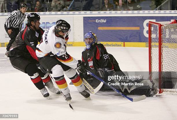 Rene Roethke of Germany tries to score past Naoya Kikuchi of Japan during the EnBW German Nations Cup match between Germany and Japan at the TUI...