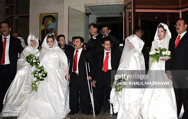 Jordanian physically-disabled couples arrive at a hotel for a mass wedding reception in Amman 09 November 2006. The Jordanian government sponsored...