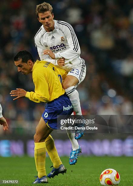 David Beckham of Real Madrid is challenged by Pichardo of Ecija in the Kings Cup fourth round second leg match at the Santiago Bernabeu stadium on...