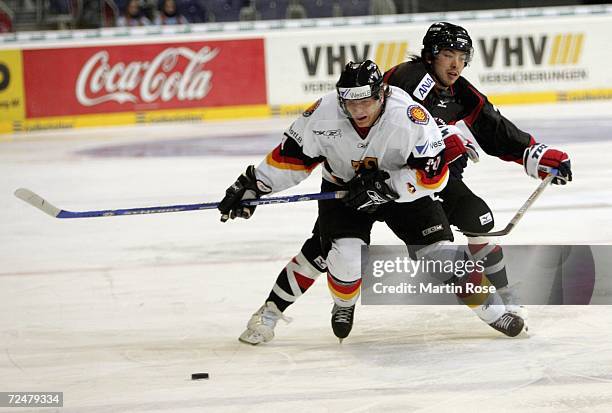 Rene Roethke of Germany and Tetsuya Saito of Japan compete the puck during the EnBW German Nations Cup match between Germany and Japan at the TUI...