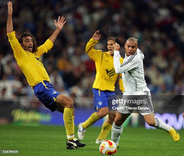 Ronaldo of Real Madrid pushes Jaime of Ecija in the Kings Cup fourth round second leg match at the Santiago Bernabeu stadium on November 9, 2006 in...
