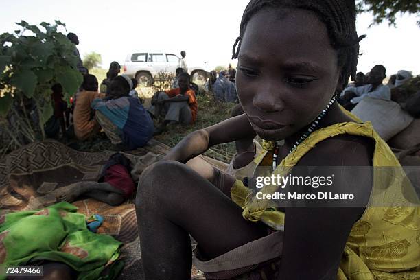 Chadian village girl shelters under trees after an attack on their village forced them to flee on November 9, 2006 in a camp for internally displaced...
