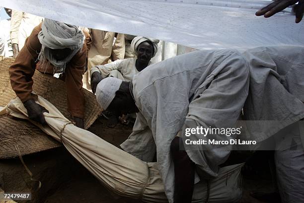 Chadian Villagers hold a funeral for a 80-years-old woman who died of natural causes as they find shelter under trees after an attack on their...
