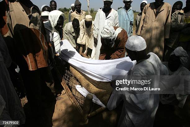 Chadian Villagers hold a funeral for a 80-years-old woman who died of natural causes as they find shelter under trees after an attack on their...