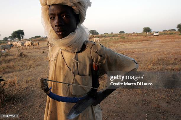 Chadian village boy carries a bow and arrows and knife after fleeing an attack on his village on November 9, 2006 in a camp for internally displaced...
