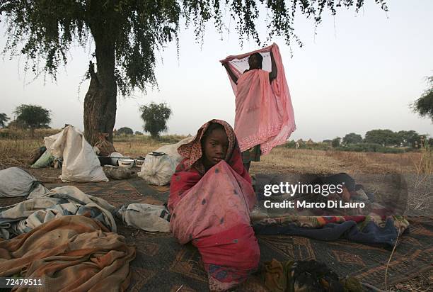 Chadian village women find shelter under trees after fleeing an attack on their village on November 9, 2006 in a camp for internally displaced...