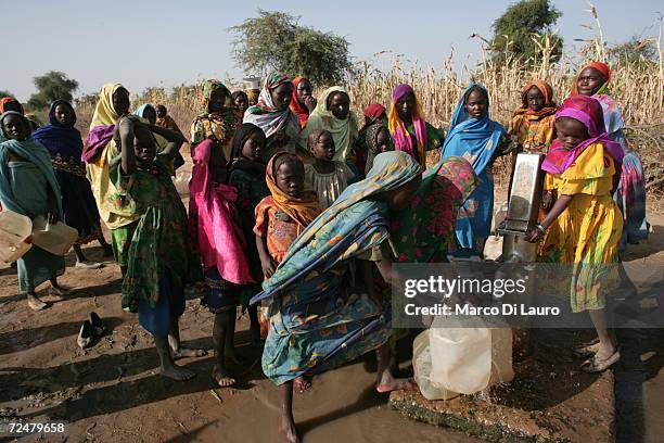 Chadian village girls collect water after an attack on their village forced them to flee on November 9, 2006 in a camp for internally displaced...