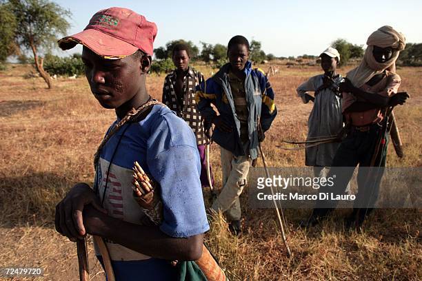 Chadian village boys carry bow and arrows after an attack on their village forced them to flee on November 9, 2006 in a camp for internally displaced...