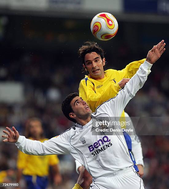 Jose Antonio Reyes of Real Madrid is challenged by Mario of Ecija in the Kings Cup fourth round second leg match at the Santiago Bernabeu stadium on...