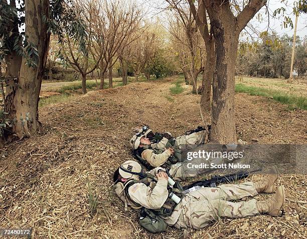 Army 3rd Division 3-7 infantry soldiers take a nap following their night guard shift on the outside perimeter of the Baghdad International Airport...