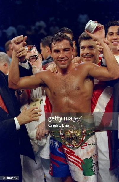 Oscar De La Hoya celebrates his 8th round TKO victory over Julio Cesar Chavez during their bout at the Thomas and Mack Center in Las Vegas, Nevada....