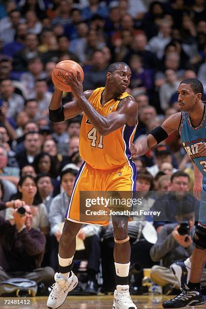 Glen Rice of the Los Angeles Lakers with the ball as Shareef Abdur-Rahim of the Vancouver Grizzlies gaurds him during the game at Staples Center in...