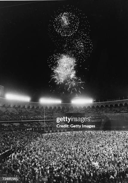 Fans pour onto the field at Busch Stadium at the conclusion of the World Series as fireworks blast overhead, St. Louis, Missouri, October 20, 1982....