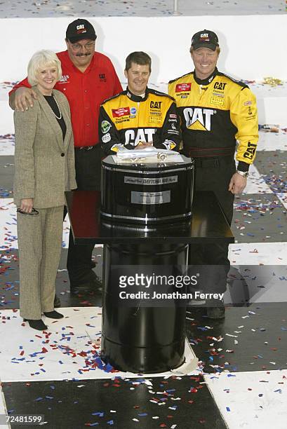Ward Burton driver of the Bill Davis Racing Dodge Intrepid R\\T celebrates with team onwers Bill and Gail Davis and crew chief Tommy Baldwin after...