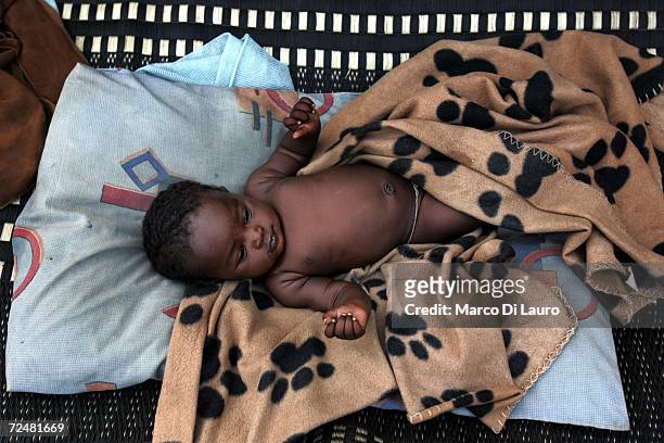 Sudanese refugee baby rests in his shelter on November 8, 2006 in the Goz Amer Refugee Camp, Chad. Since 2004 refugees have fled from Darfur into the...