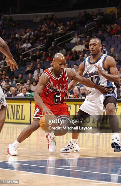 Travis Best of the Chicago Bulls drives past Chris Whitney of the Washington Wizards during their game at MCI Center in Washington, D.C. The Wizards...