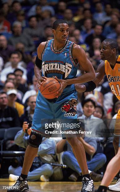 Shareef Abdur-Rahim of the Vancouver Grizzlies with the ball as Glen Rice of the Los Angeles Lakers gaurds him during the game at Staples Center in...