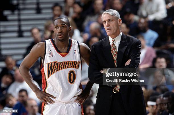 Head coach Brian Winters of the Golden State Warriors talks to his guard Gilbert Arenas, during the NBA game against the Minnesota Timberwolves at...