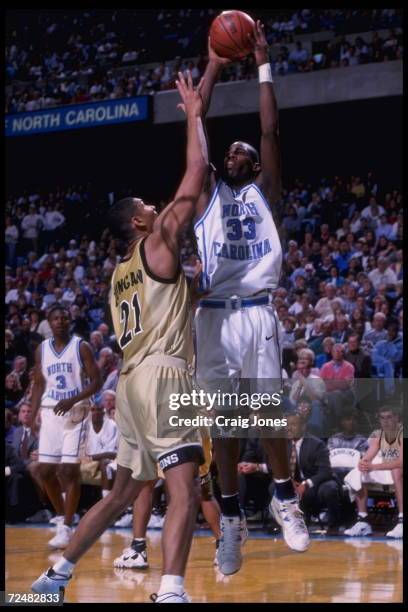 Forward Antawn Jamison of the University of North Carolina Tar Heels attempts a jumper over the head of center Tim Duncan of the Wake Forest Demon...