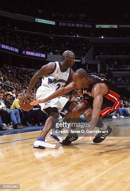 Guard Michael Jordan of the Washington Wizards fakes out forward LaPhonso Ellis of the Miami Heat during the NBA game at the MCI Center in...